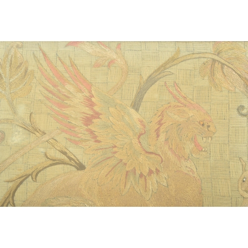 582 - A late 19th / early 20th century tapestry depicting a winged griffin slaying a snake. With bead deta... 