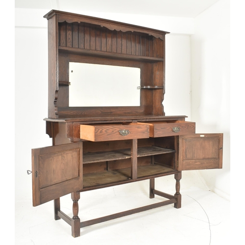 587 - G. Hardy & Co Ltd - a 20th century oak Welsh dresser with mirror. The dresser having a shaped ap... 