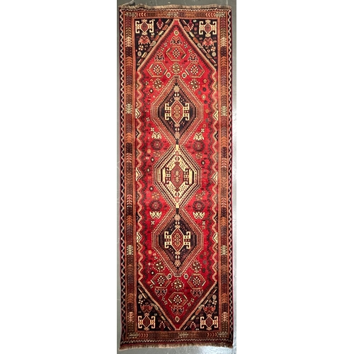 592 - A 20th century South West Persian Islamic Qashgai floor carpet runner rug. The rug having three cent... 