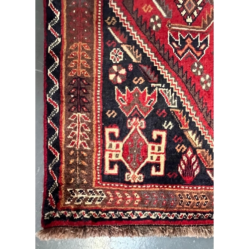 592 - A 20th century South West Persian Islamic Qashgai floor carpet runner rug. The rug having three cent... 