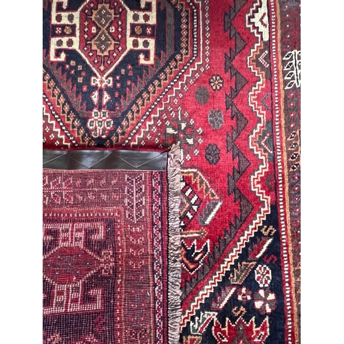 592 - A 20th century South West Persian Islamic Qashgai floor carpet runner rug. The rug having three cent... 