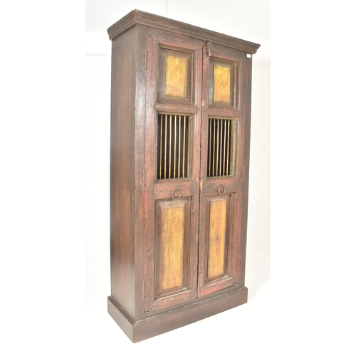 594 - A 19th century Indian stained teak housekeeper / kitchen cupboard. The cupboard having a two full le... 