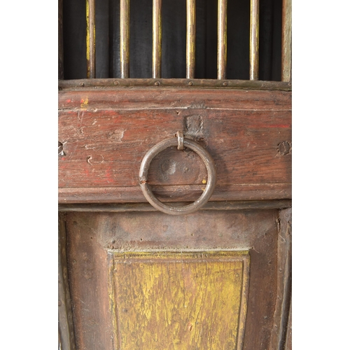 594 - A 19th century Indian stained teak housekeeper / kitchen cupboard. The cupboard having a two full le... 