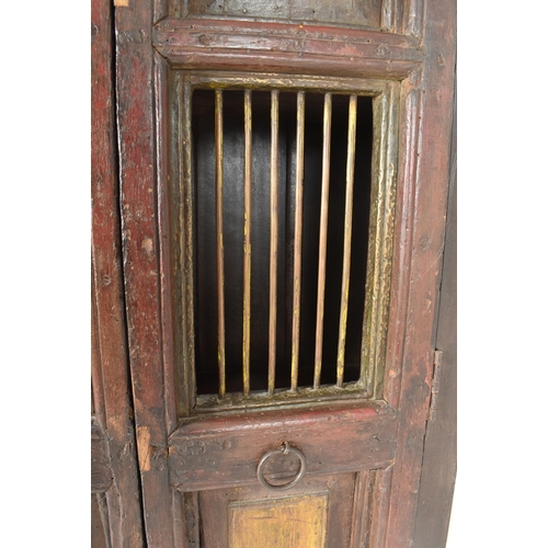 594 - A 19th century Indian stained teak housekeeper / kitchen cupboard. The cupboard having a two full le... 