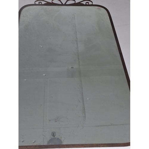 521 - A large vintage wrought iron wall mantel mirror. The mirror having scrolled iron embellishment atop ... 