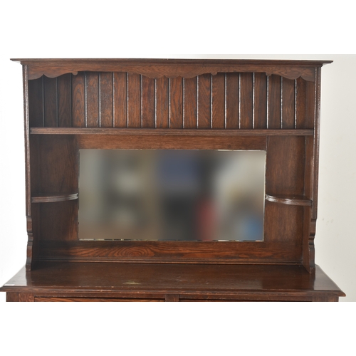 587 - G. Hardy & Co Ltd - a 20th century oak Welsh dresser with mirror. The dresser having a shaped ap... 