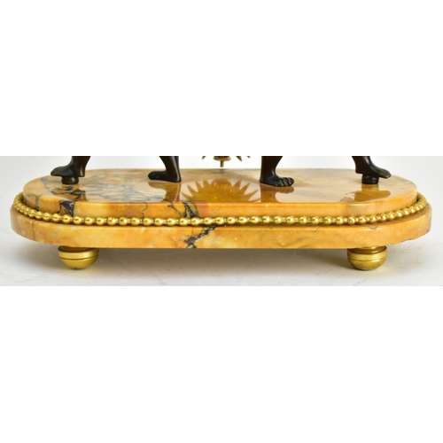 20 - A 19th century French Empire style mantle clock, along with two candlestick garnitures. The clock wi... 