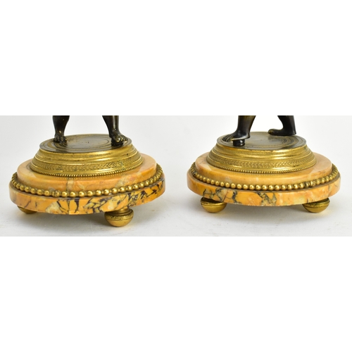 20 - A 19th century French Empire style mantle clock, along with two candlestick garnitures. The clock wi... 