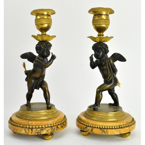 20 - A 19th century French Empire style mantle clock, along with two candlestick garnitures. The clock wi... 