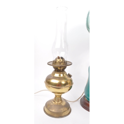 10 - A collection of three late 19th century oil lamps, one converted to electric. Featuring two brass bo... 