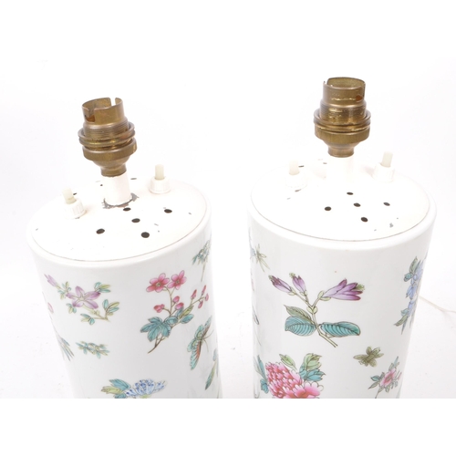 11 - A pair of mid 20th century Chinese manner ceramic table lamps. Each raised on hardwood bases, with w... 