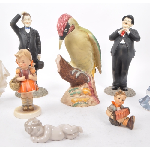 130 - A collection of eight 20th-century ornaments and figurines, comprising of a Beswick 1218 'Woodpecker... 