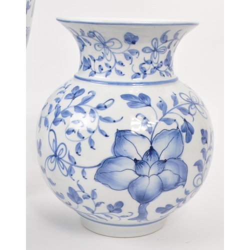 141 - A collection of five 20th-century Chinese porcelain/pottery pieces, each with a blue and white flora... 