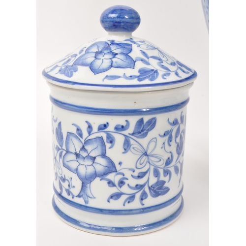 141 - A collection of five 20th-century Chinese porcelain/pottery pieces, each with a blue and white flora... 