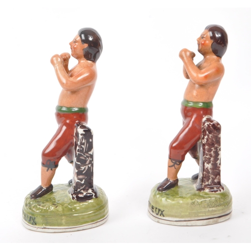 161 - Tom Molyneux - A pair of 19th century Staffordshire ceramic boxer figures. The figures each in the f... 