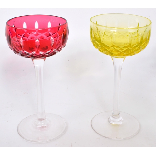 173 - A set of six 1930s John Walsh Harlequin hock glass, each with colour cased mitre cut bowl above a sl... 