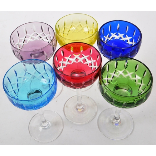 173 - A set of six 1930s John Walsh Harlequin hock glass, each with colour cased mitre cut bowl above a sl... 