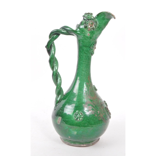 20 - A 19th century Turkish Ottoman canakkale pottery ewer, with a green glaze. Featuring a braided handl... 