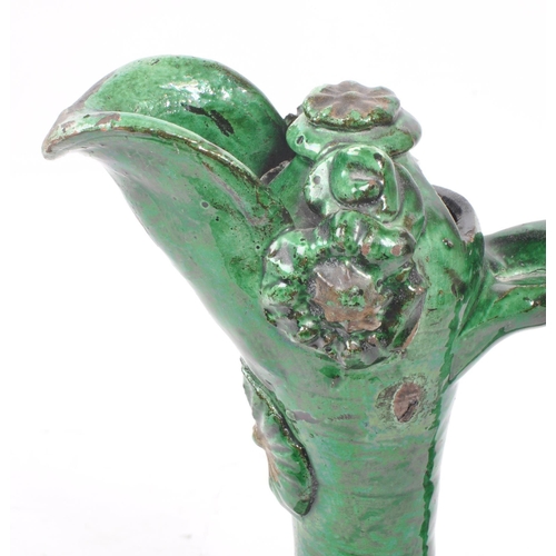 20 - A 19th century Turkish Ottoman canakkale pottery ewer, with a green glaze. Featuring a braided handl... 