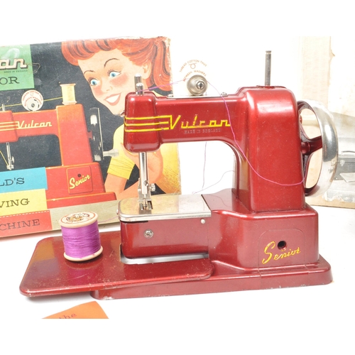 203 - Two vintage mid century child's sewing machine, comprising of a Vulcan senior model, in maroon and a... 