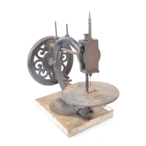 206 - A vintage 19th century cast iron sewing machine, with a marble base. Featuring a ceramic hand crank,... 