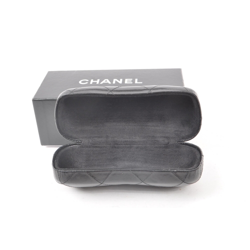 208 - A Chanel black glasses case, with the original box, drawstring bag and paperwork. Measuring approx. ... 