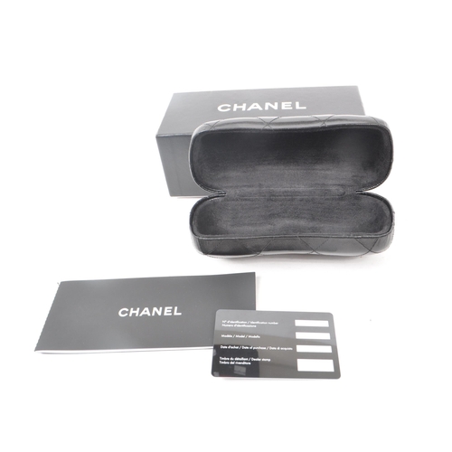 208 - A Chanel black glasses case, with the original box, drawstring bag and paperwork. Measuring approx. ... 