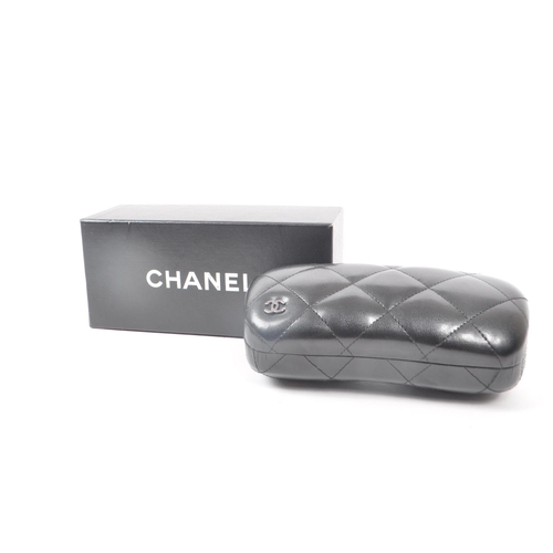 208 - A Chanel black glasses case, with the original box, drawstring bag and paperwork. Measuring approx. ... 