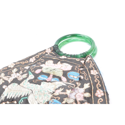 209 - A vintage 1920s Chinese hand-stitched bag / handbag. Featuring two green, glass circular handles, bl... 