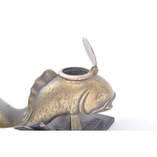 210 - An early 20th century Japanese brass inkwell, in the shape of a fish mounted on a wooden base. Inkwe... 