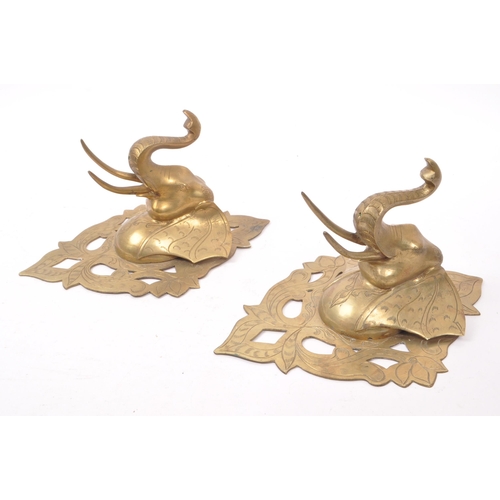 214 - Two vintage 20th century brass elephant sconces, with carved detailing featuring floral shapes and e... 