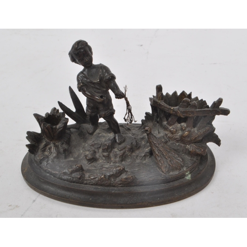 217 - A vintage early 20th century brass cast fisherman boy figure, mounted on an oval base. Showing a fig... 