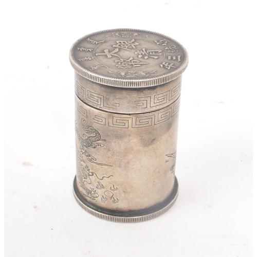 220 - A vintage 20th century Chinese fat man coin style cylindrical box. With a fat man coin style piece o... 