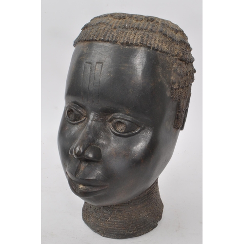 225 - A vintage early 20th century bronze metal African tribal bust, of a woman. Hollow to the inside of t... 