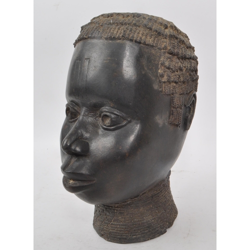 225 - A vintage early 20th century bronze metal African tribal bust, of a woman. Hollow to the inside of t... 