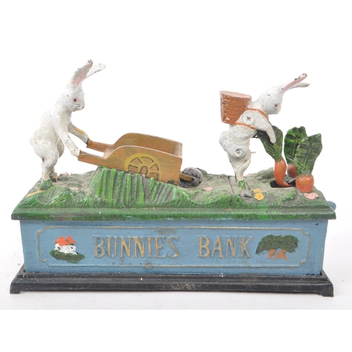 227 - A pair of vintage reproduction cast iron money boxes, comprising of: A 'Bunnies Bank' with two white... 