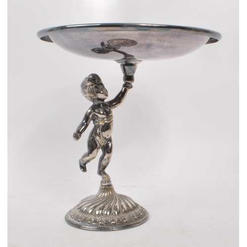 231 - A 20th century silver plated putti tazza, alongside a gilt brass cast stag figure. The tazza raised ... 