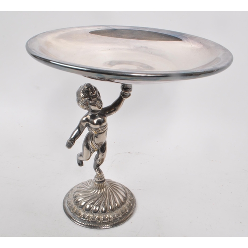 231 - A 20th century silver plated putti tazza, alongside a gilt brass cast stag figure. The tazza raised ... 