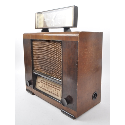 234 - A mid 20th century Coral clock alongside an Ultra radio. The clock having bakelite casing with iridi... 