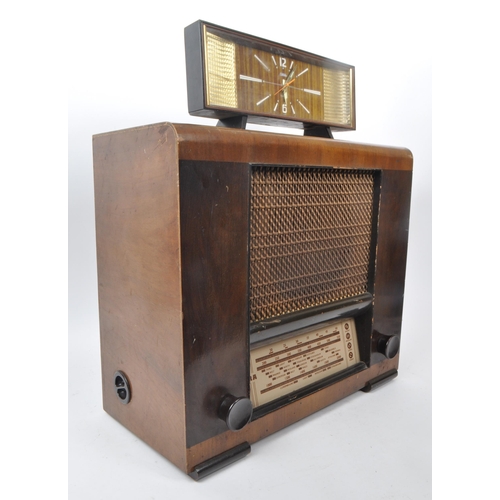 234 - A mid 20th century Coral clock alongside an Ultra radio. The clock having bakelite casing with iridi... 