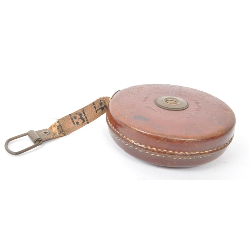 238 - A set of two vintage 1960s leather cased surveyor tape measures, one by John Rabone & Sons, Birm... 