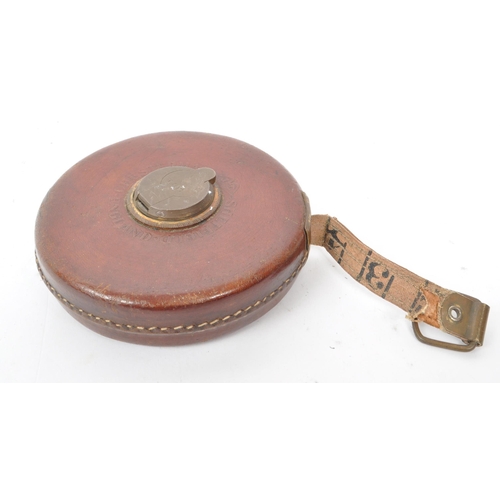 238 - A set of two vintage 1960s leather cased surveyor tape measures, one by John Rabone & Sons, Birm... 