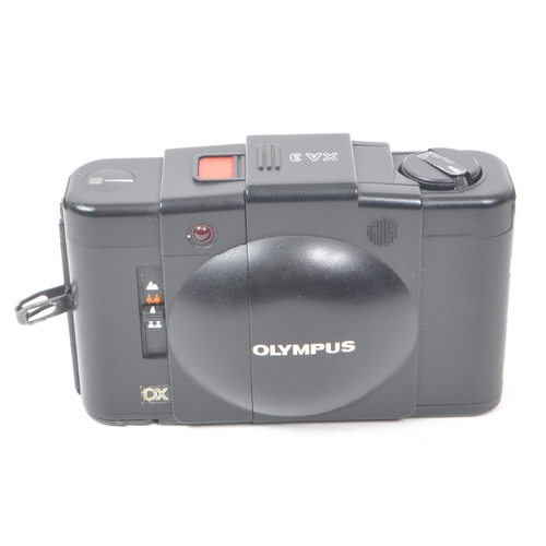 243 - Olympus - A collection of late 20th century Olympus XA range 35mm rangefinder / viewfinder cameras. ... 