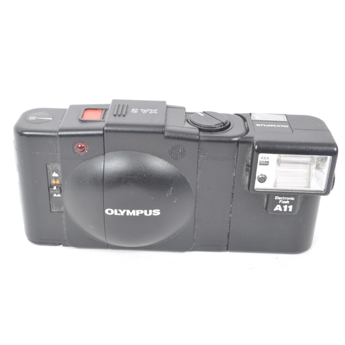 243 - Olympus - A collection of late 20th century Olympus XA range 35mm rangefinder / viewfinder cameras. ... 