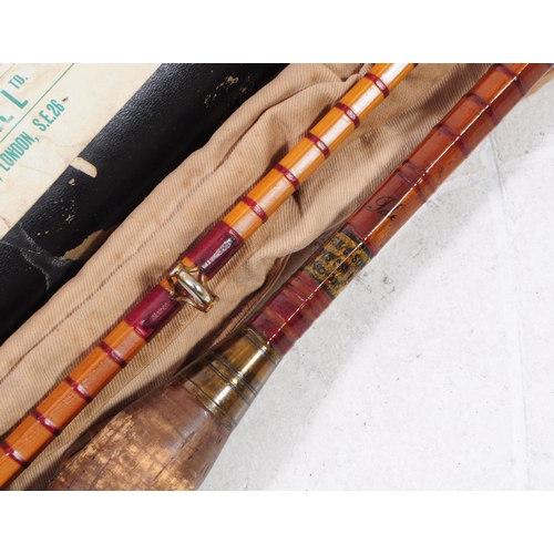 249 - A vintage 20th century split cane fishing rod. Having cloth casing and tube packaging. Y. E. Haswell... 