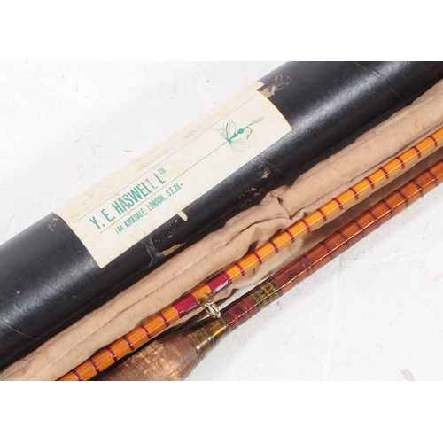 249 - A vintage 20th century split cane fishing rod. Having cloth casing and tube packaging. Y. E. Haswell... 