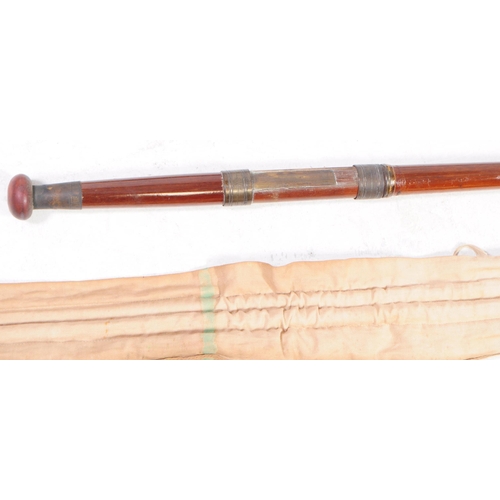 249 - A vintage 20th century split cane fishing rod. Having cloth casing and tube packaging. Y. E. Haswell... 