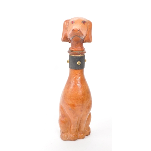 251 - A leather covered glass decanter with a rubber stopper, designed to look like a dog. Additional feat... 