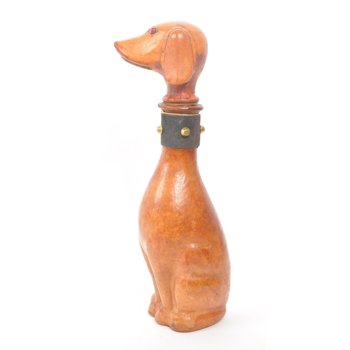 251 - A leather covered glass decanter with a rubber stopper, designed to look like a dog. Additional feat... 