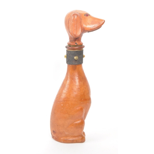 251 - A leather covered glass decanter with a rubber stopper, designed to look like a dog. Additional feat... 